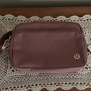 NWT-lululemon athletica mauve-pink crossbody bag with rose gold logo